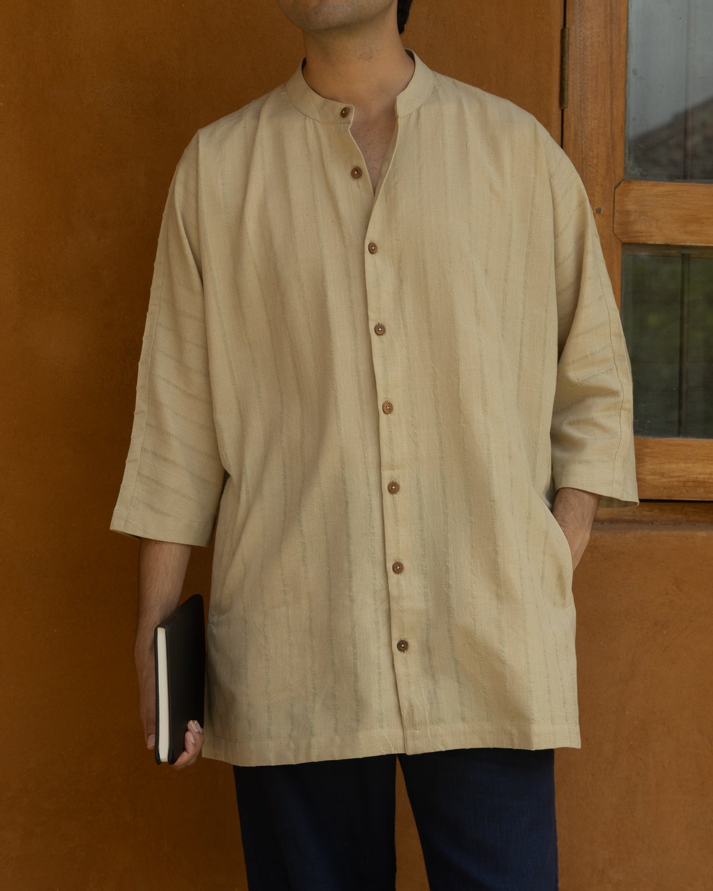 Earthy olive green khadi cotton kimono shirt for men with 3/4 sleeves, handwoven using traditional handloom techniques.