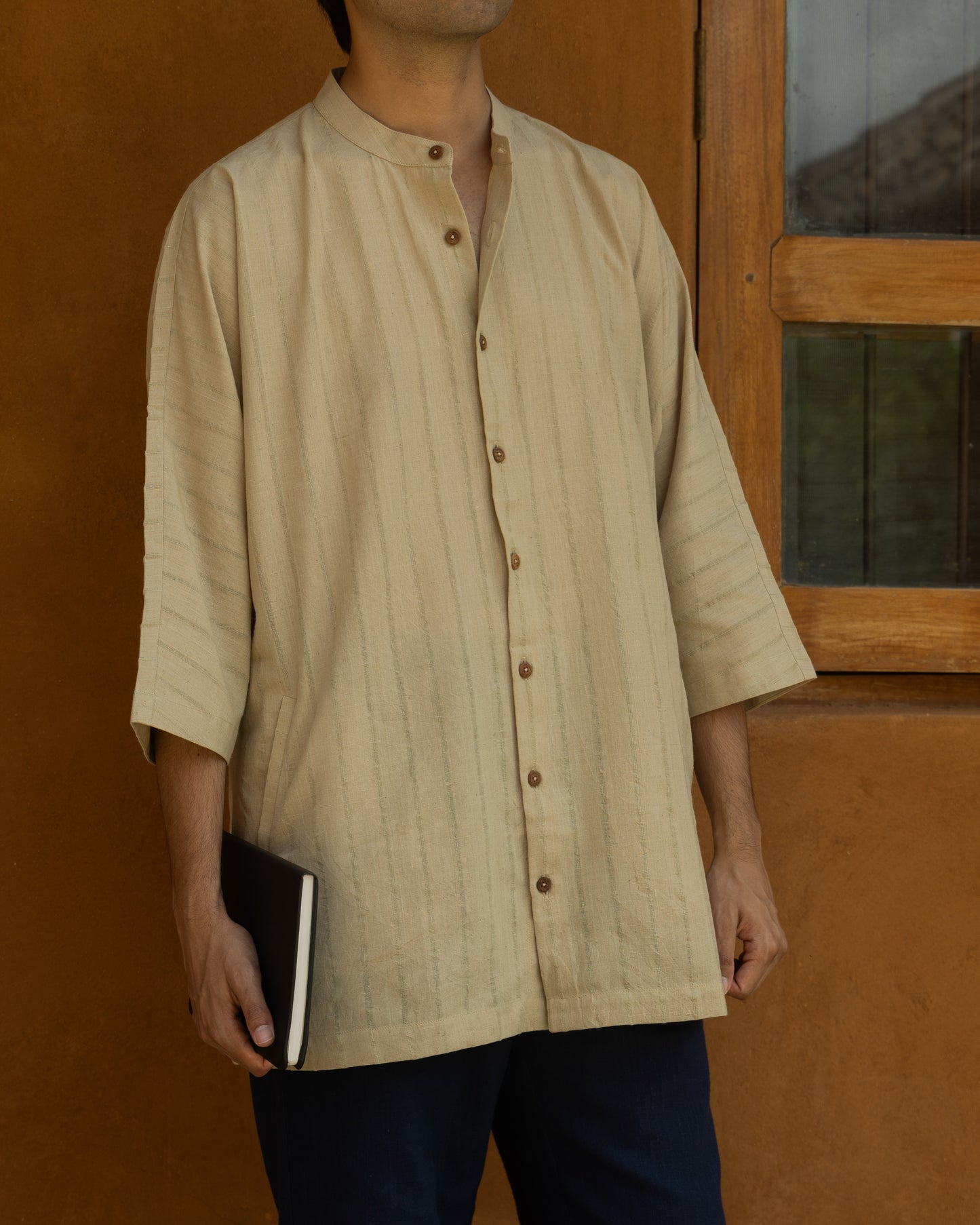 Organic cotton kimono-style shirt in basil green for men, featuring a relaxed fit, quarter sleeves, and Japanese-inspired silhouette.