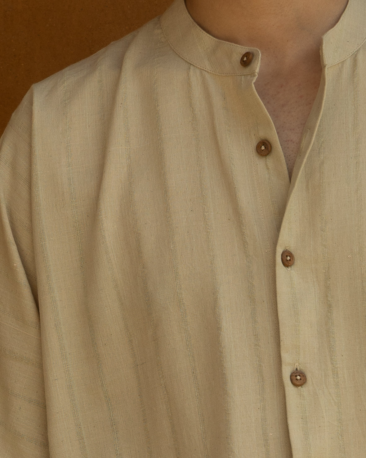 Handspun khadi shirt for men in pastel olive tones with kimono sleeves and a breathable, eco-friendly finish for modern everyday wear.