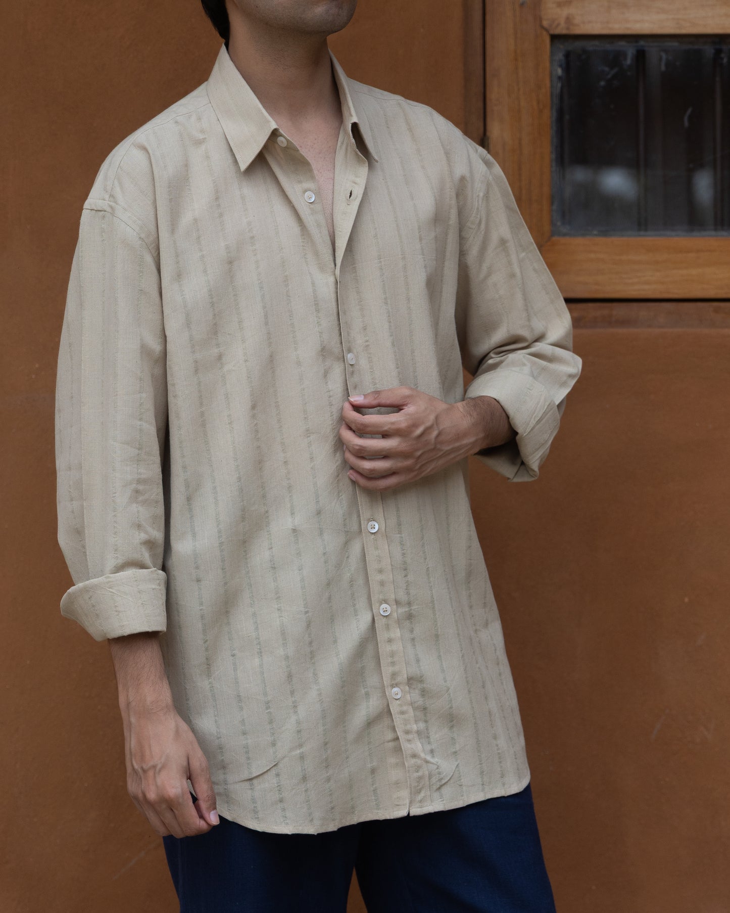 Eco-friendly olive green handloom shirt for men featuring a loose, comfortable fit and soft texture in organic khadi cotton.