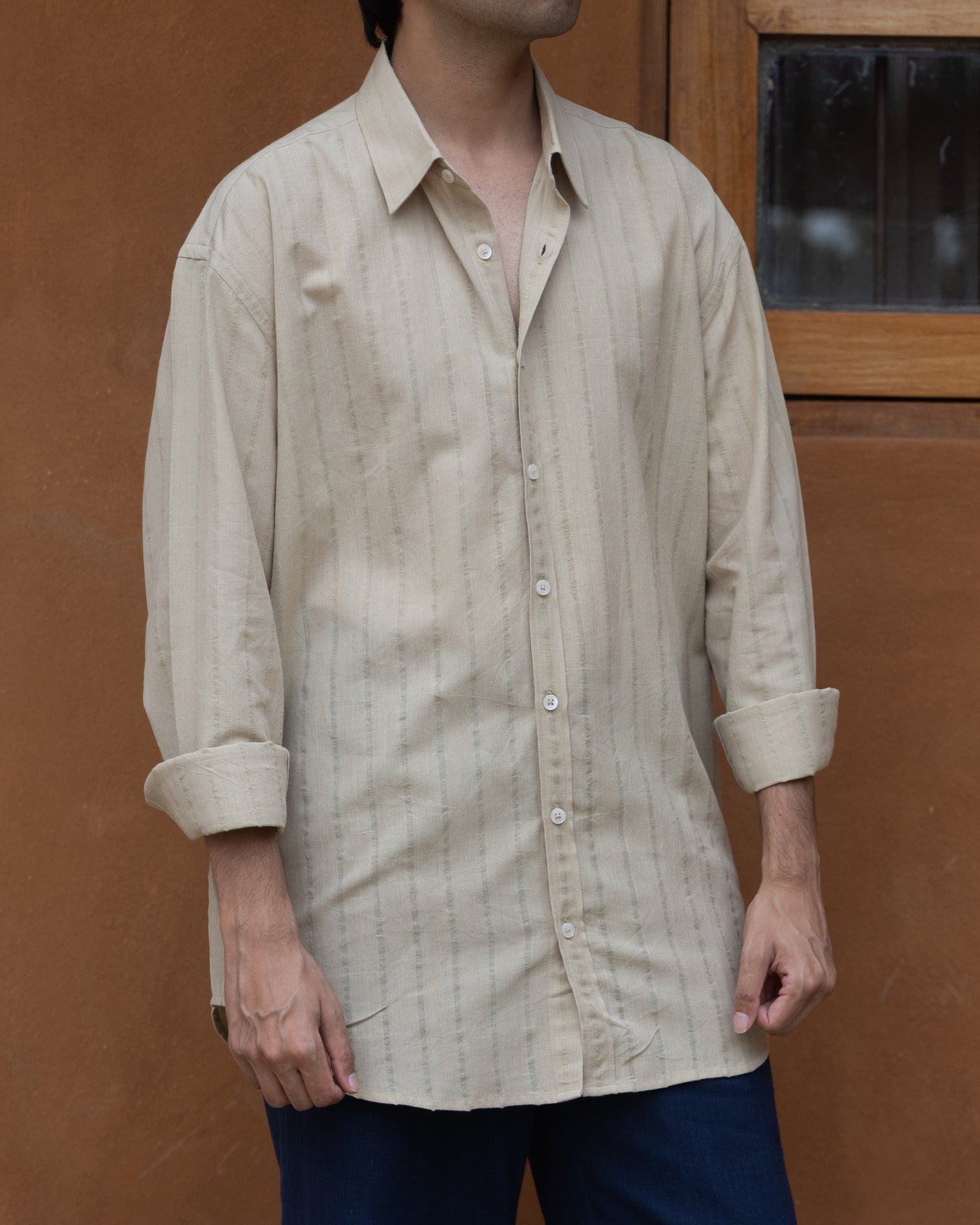 Handspun khadi shirt in earthy basil green with a relaxed silhouette, perfect for sustainable and everyday luxury menswear.