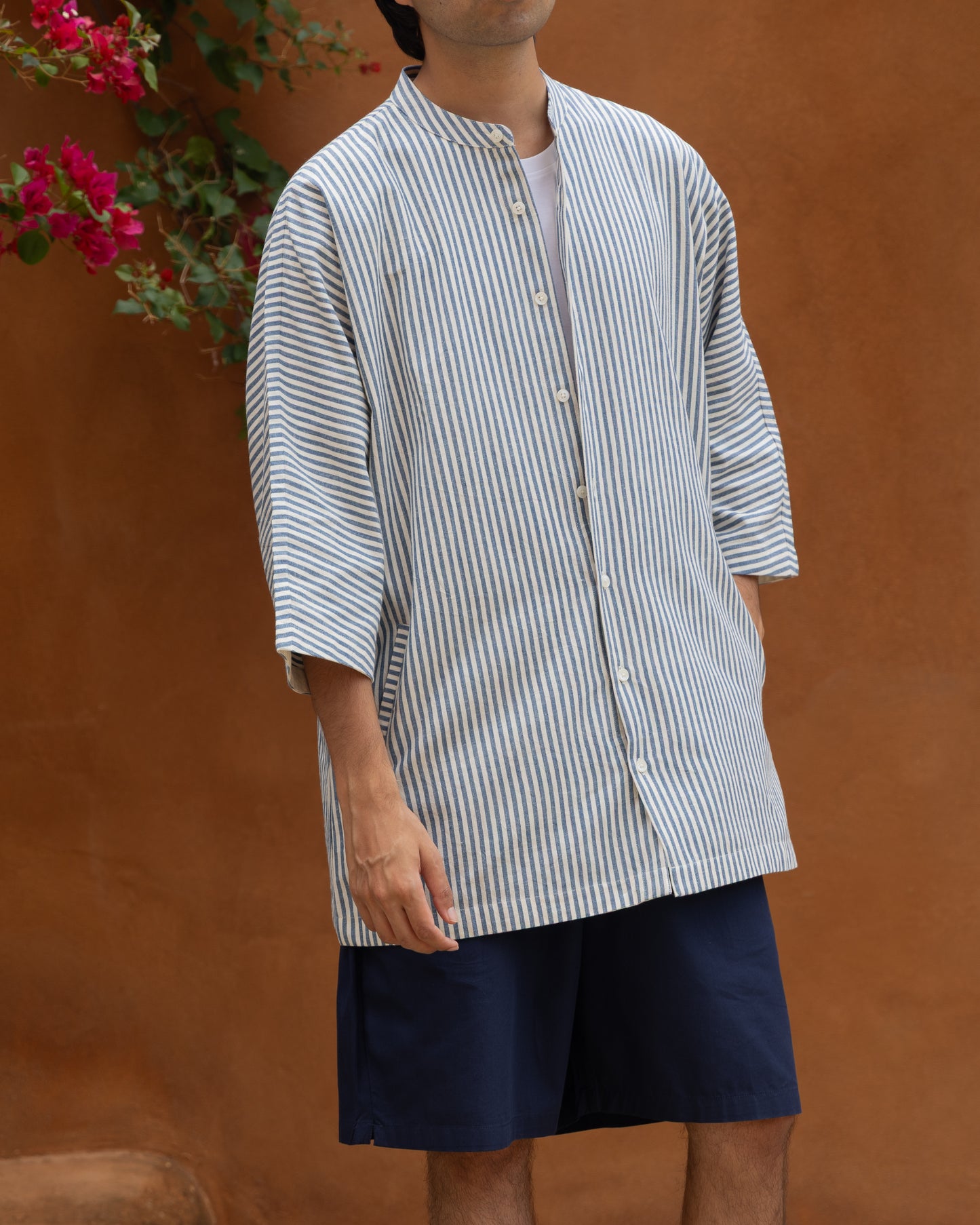 Handloom Khadi shirt with blue stripes for men, featuring kimono-style sleeves and crafted from breathable organic cotton.