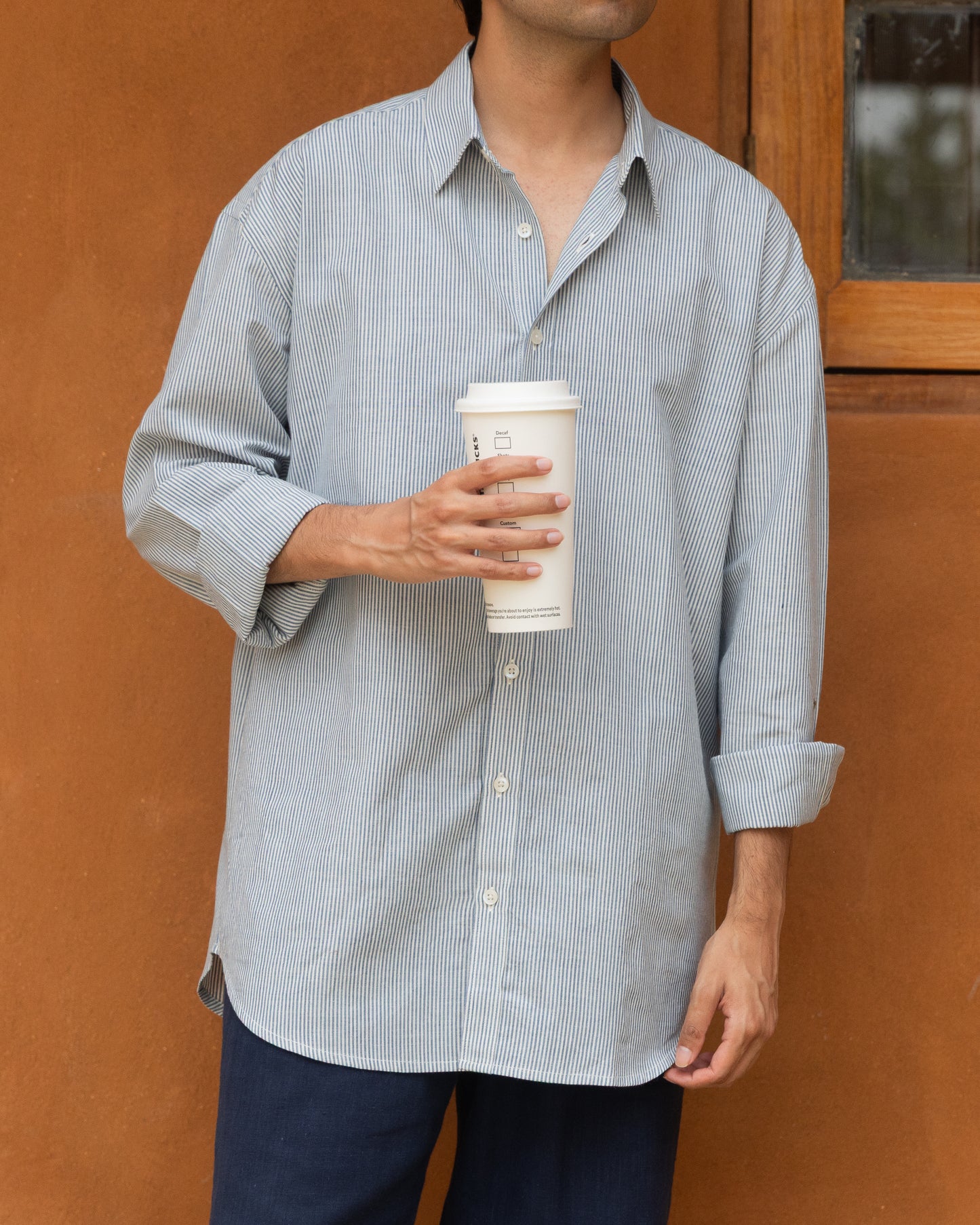 Pastel blue striped khadi cotton shirt for men with a relaxed fit, handwoven from organic fabric for an airy, eco-friendly feel.