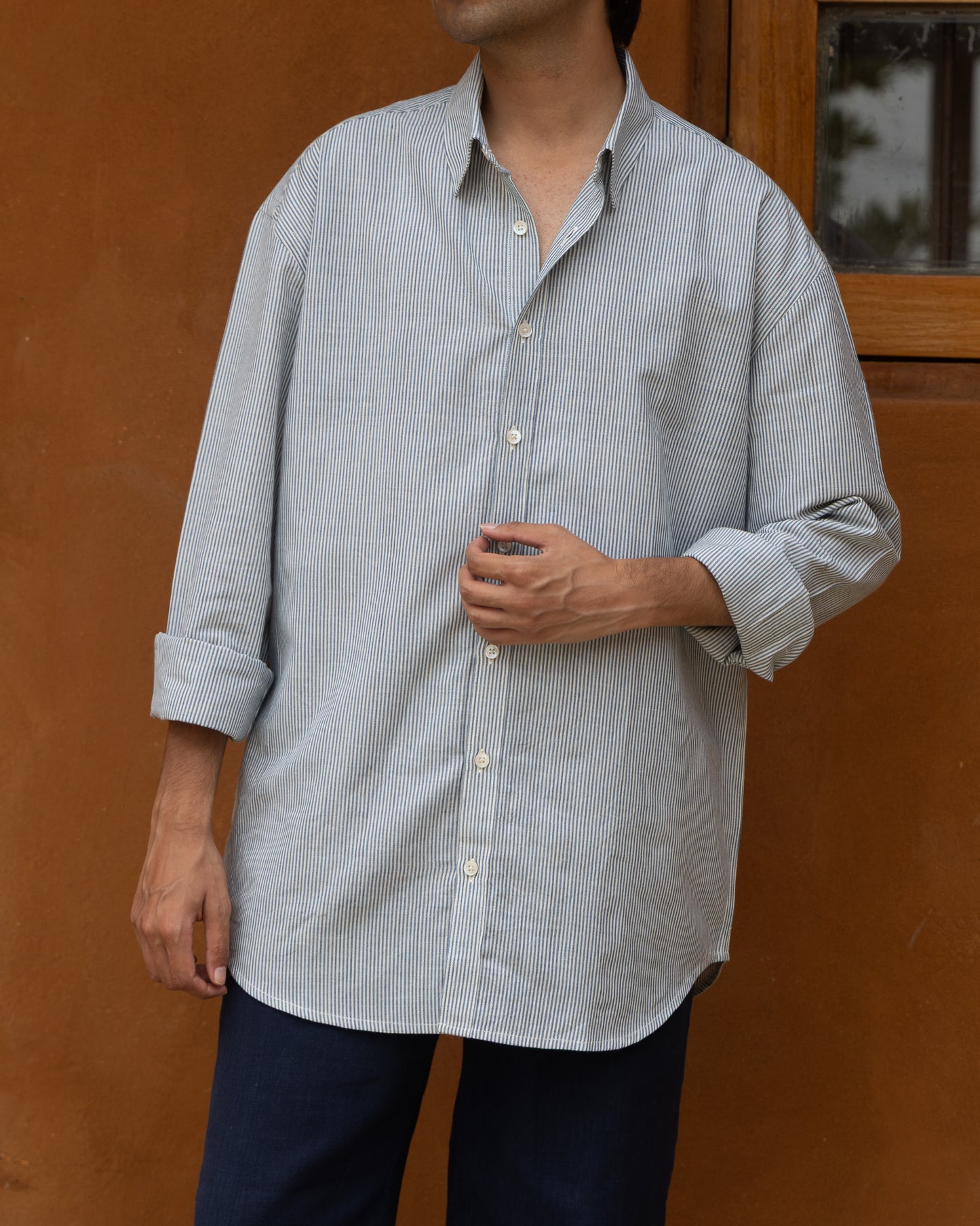 Capri blue handwoven shirt for men made from organic khadi cotton, featuring light stripes and a loose, comfortable silhouette.