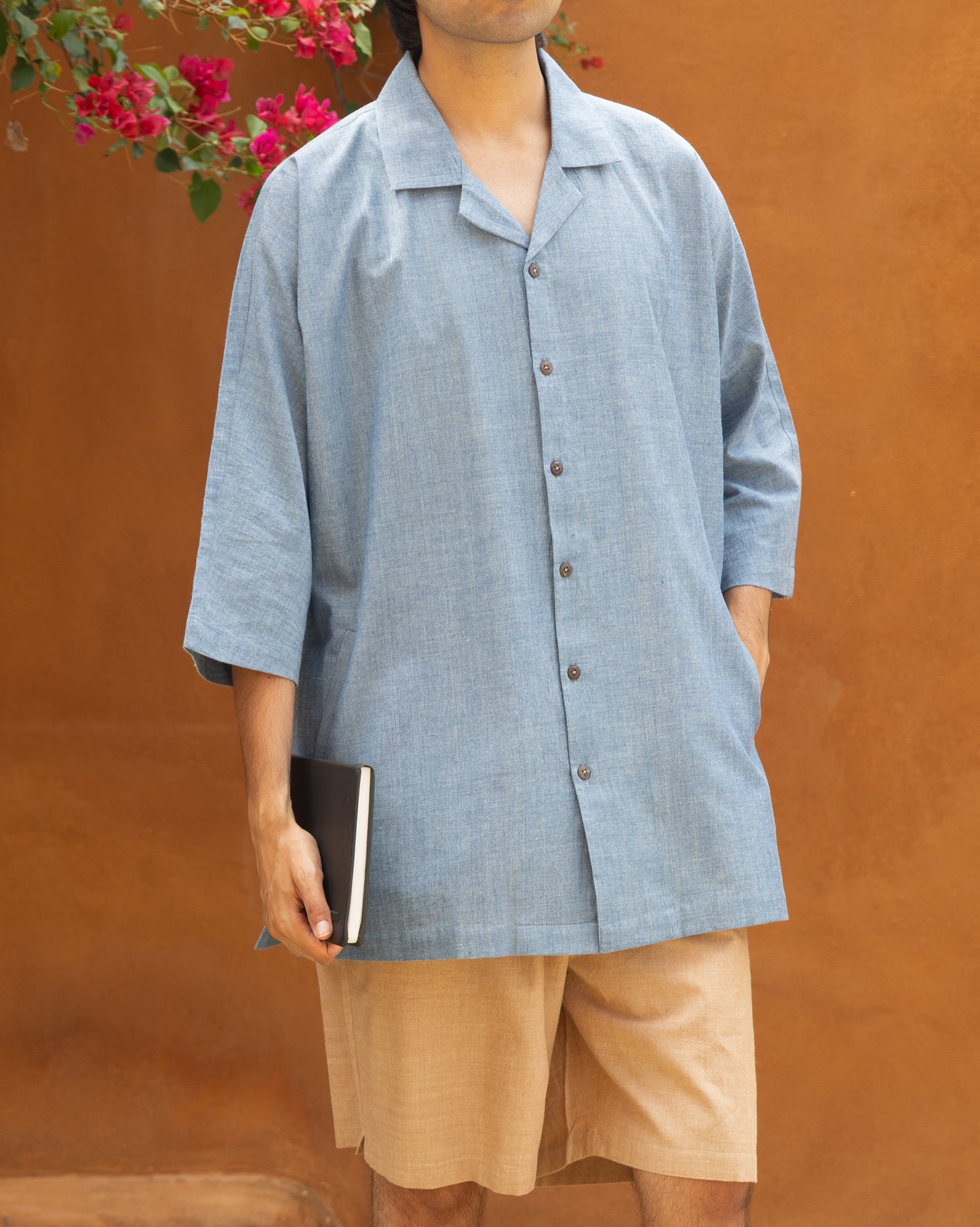 Model wearing chambray blue camp collar kimono shirt made from handwoven Khadi cotton – eco-friendly and organic shirt for men.