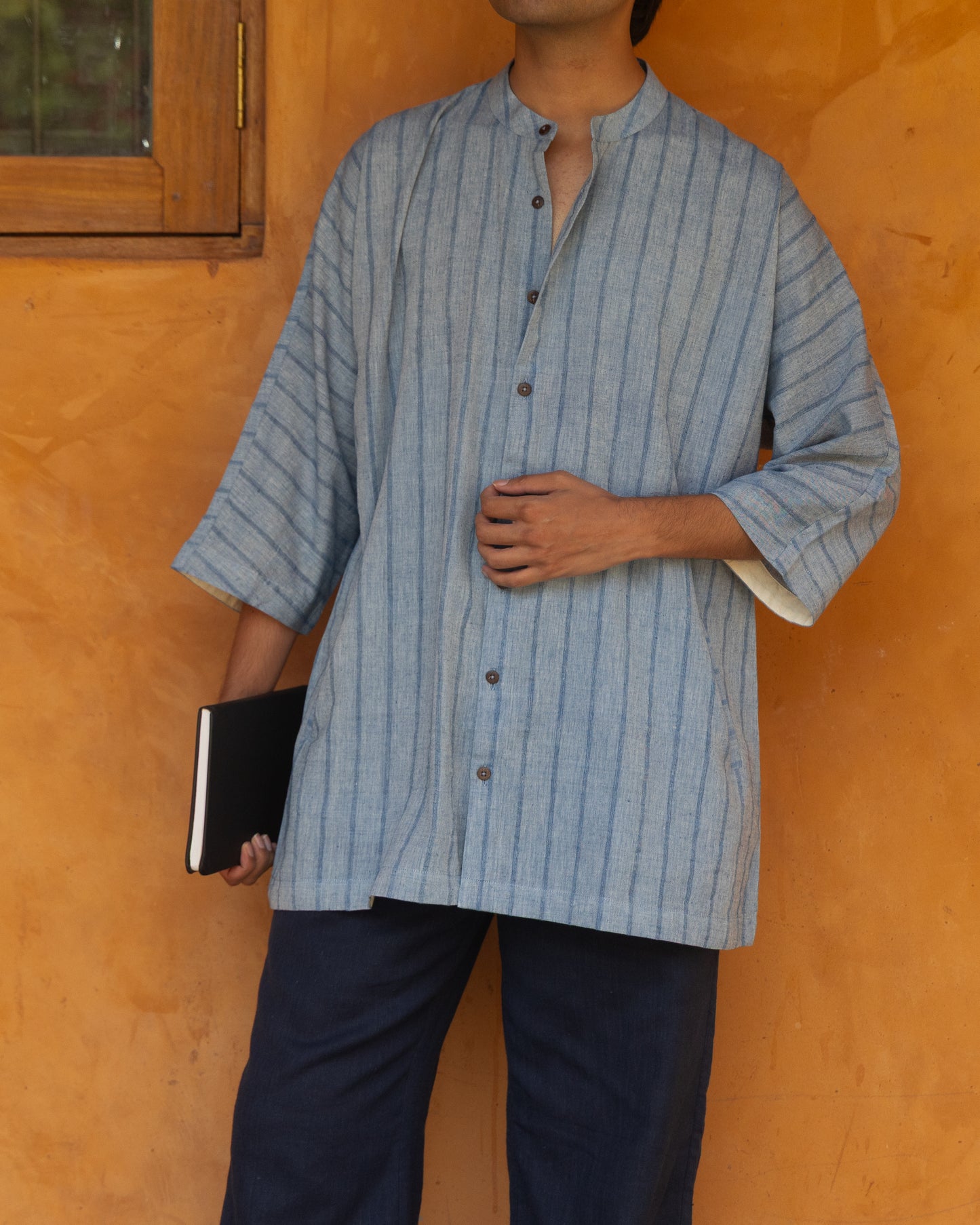 Eco-friendly men's shirt in earthy indigo tones featuring a kimono-style cut, crafted from handloom khadi cotton with quarter-length sleeves.