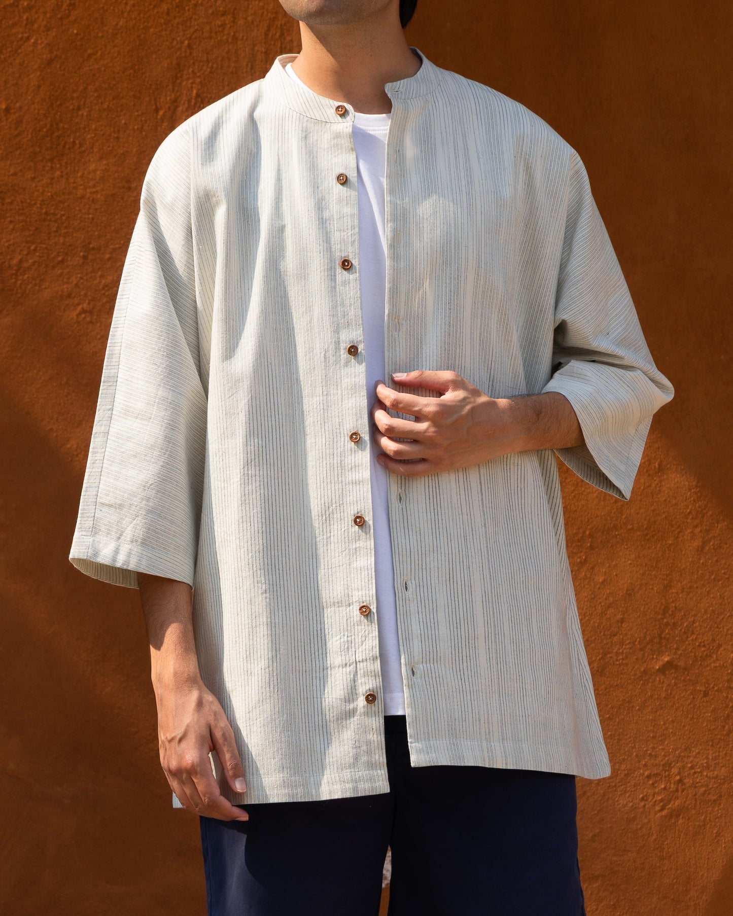 Men's Kora indigo faded stripes Khadi cotton kimono sleeve shirt, soft indigo earthy tone, crafted from organic cotton and handloom fabric.