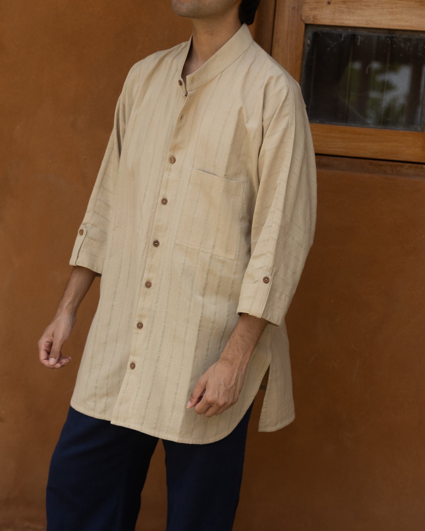 Earthy olive green handwoven kimono shirt for men made from organic cotton, featuring quarter sleeves and a breathable, natural texture.