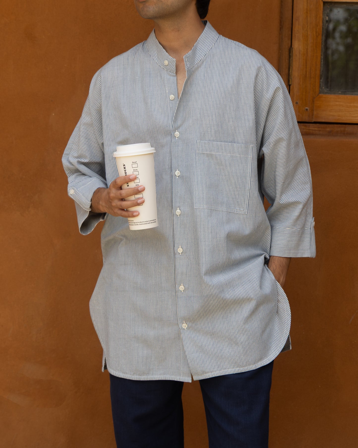 Handwoven khadi shirt for men in light capri blue stripes with kimono-style 3/4 sleeves and breathable organic cotton fabric.