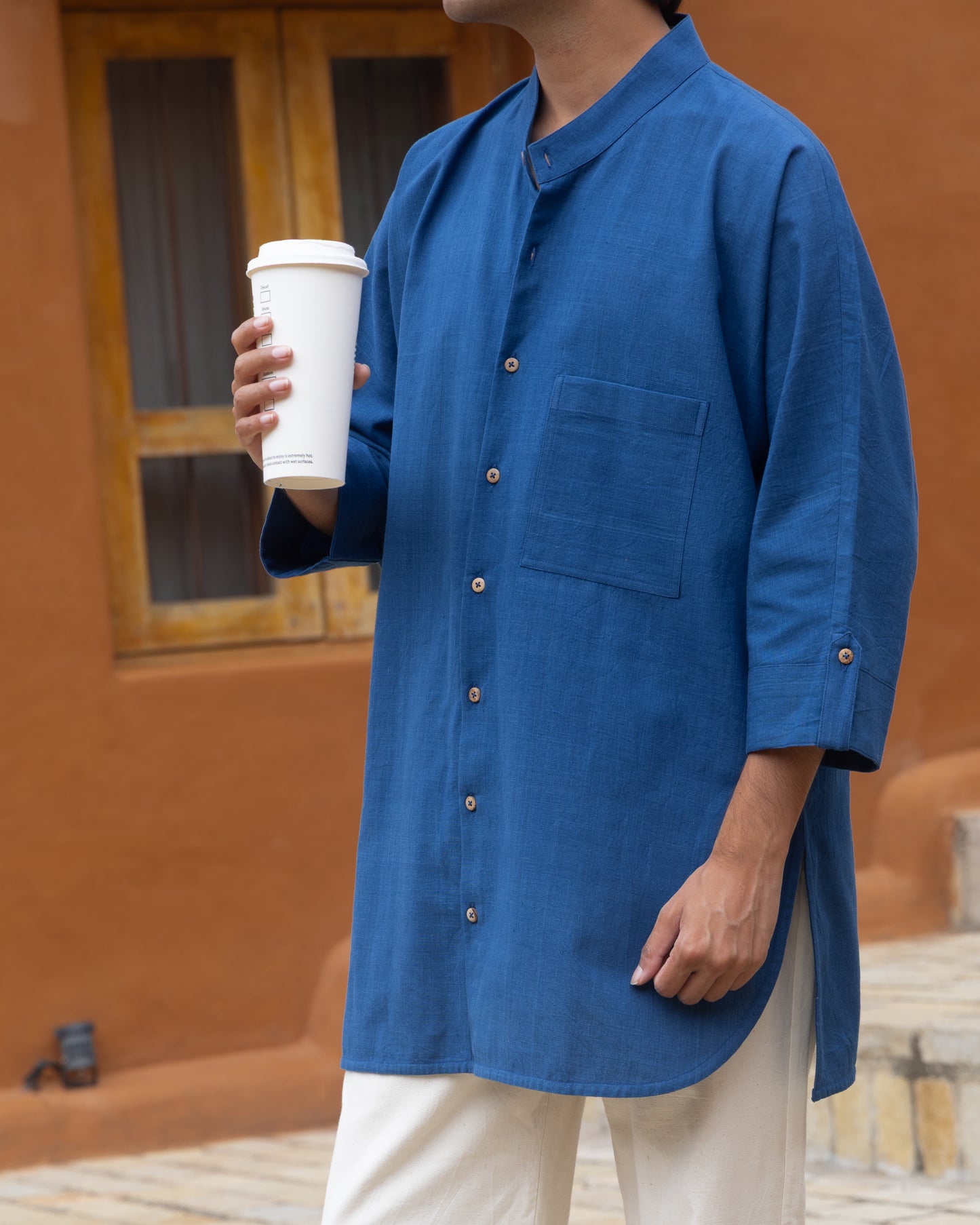 Indigo-dyed men’s kimono-style shirt featuring a soft, breathable khadi cotton weave with quarter sleeves and a loose, flowing silhouette.