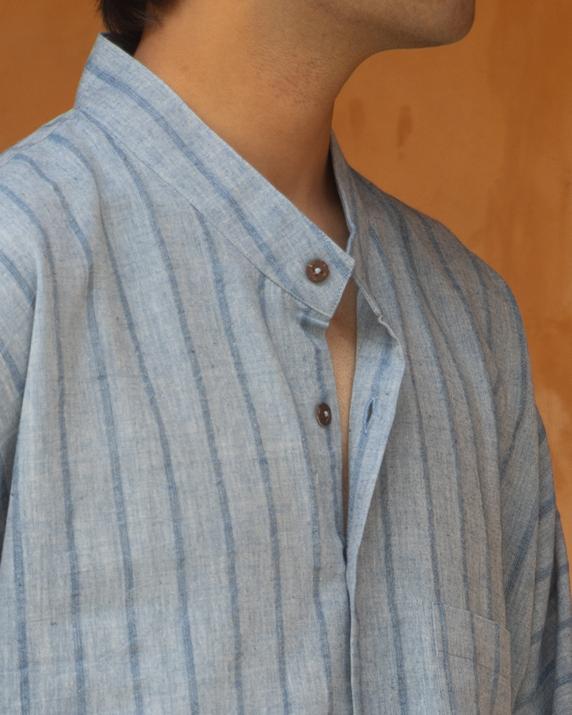 Eco-friendly long kimono shirt for men in deep indigo tones, crafted from organic handwoven cotton with quarter-length sleeves.