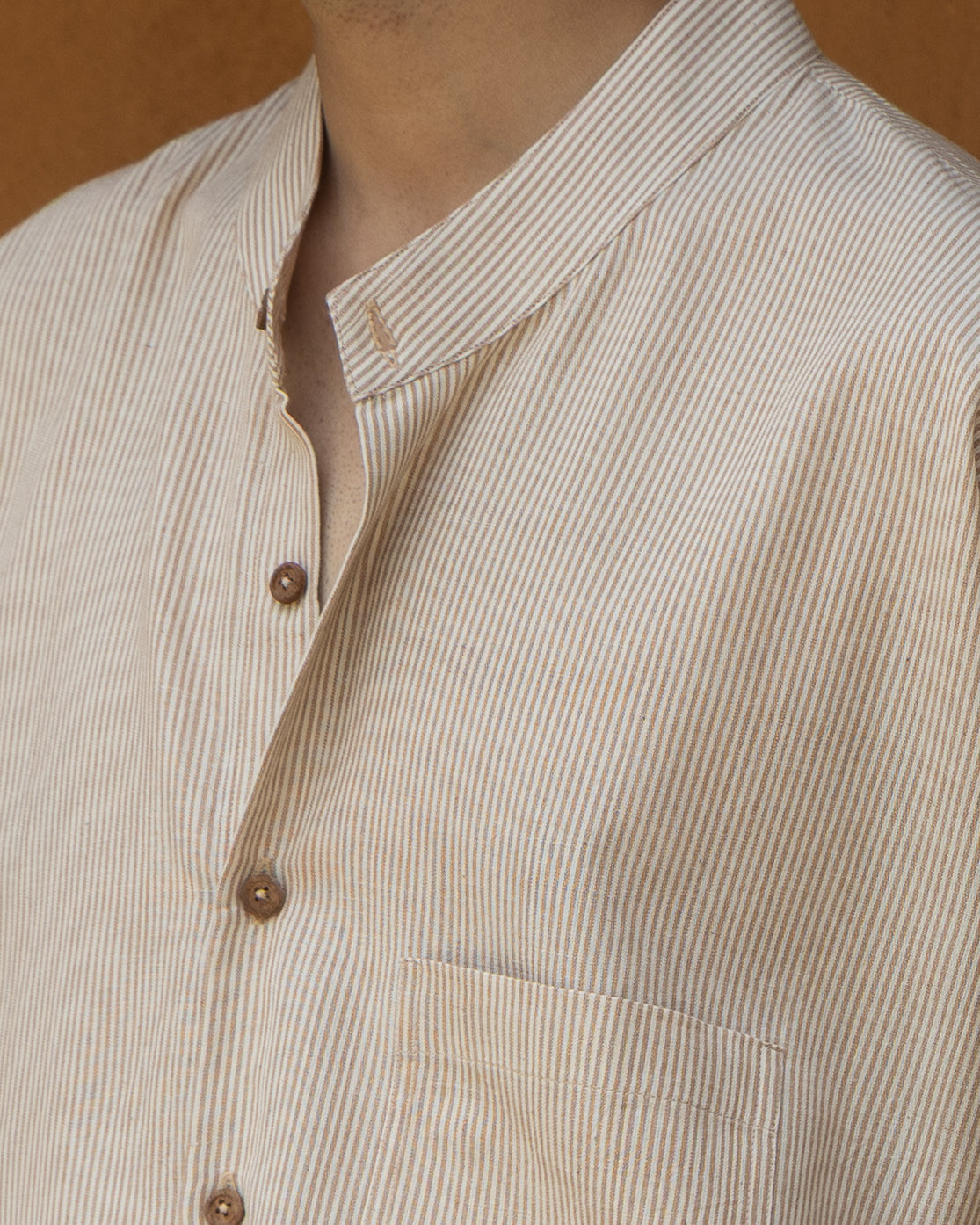 Men’s organic cotton kimono shirt in nutbrown hues with a breathable weave, quarter sleeves, and artisanal handloom finish.