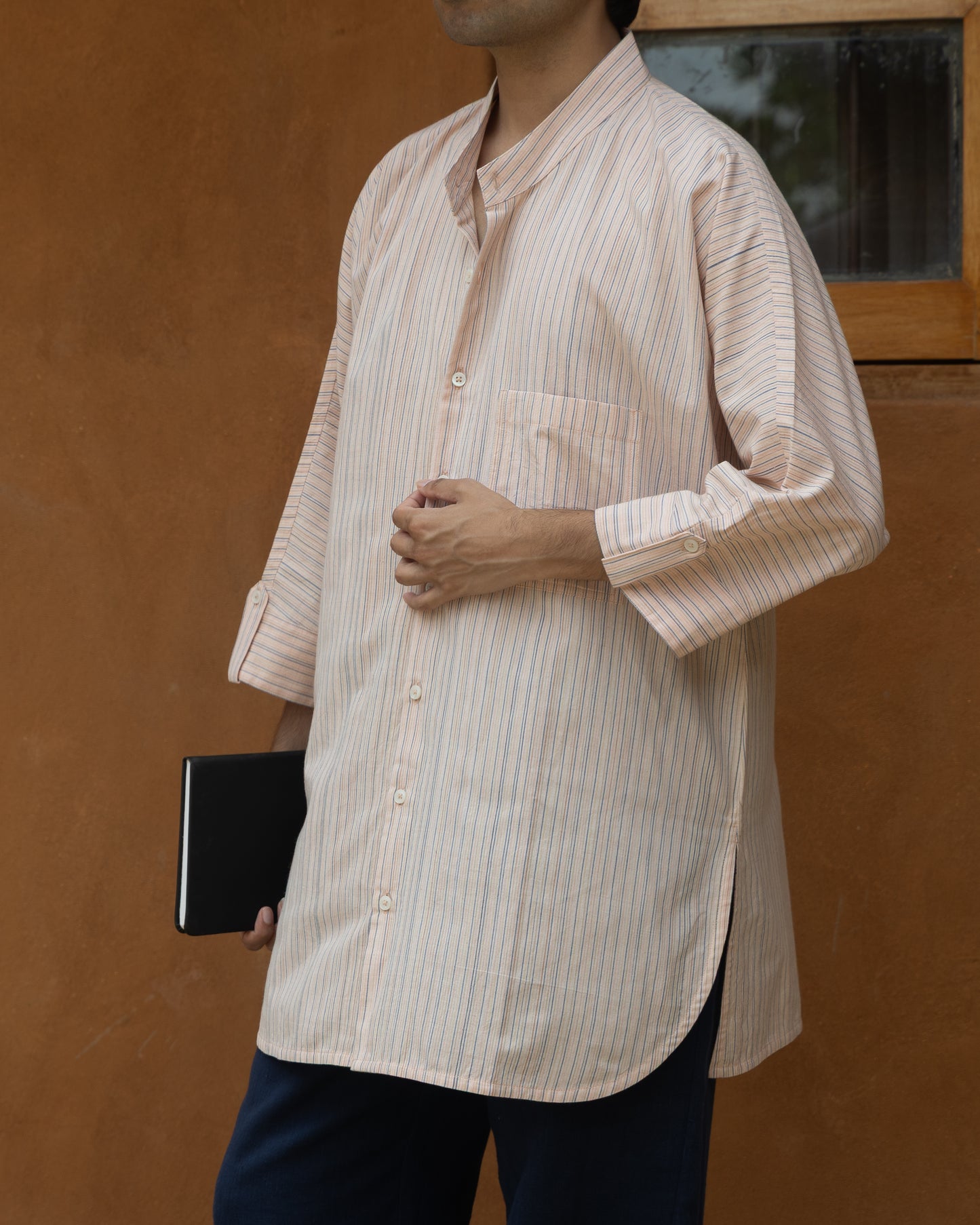 Pink guava multi-stripe kimono shirt for men featuring a long silhouette, quarter sleeves, and handspun khadi cotton construction.