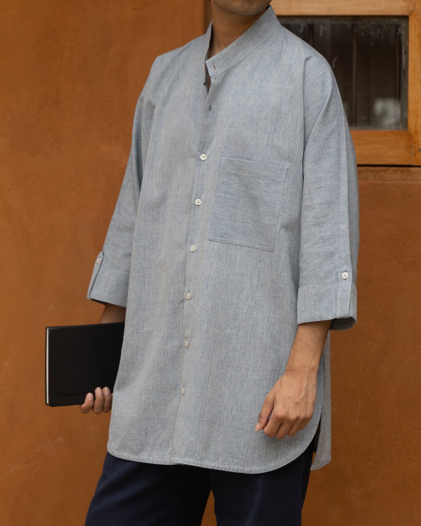 Eco-friendly long kimono shirt in soft indigo mélange, featuring handloom organic cotton, 3/4 sleeves, and an airy, earthy silhouette.