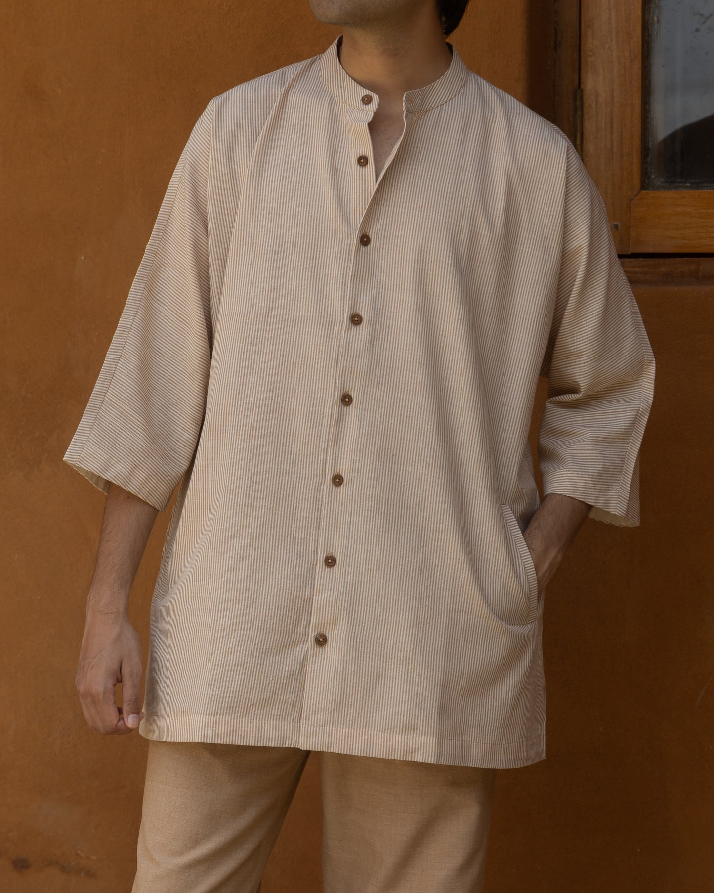 Eco-friendly men’s kimono-style shirt in organic handloom khadi with brown and beige stripes and a relaxed quarter-sleeve fit.