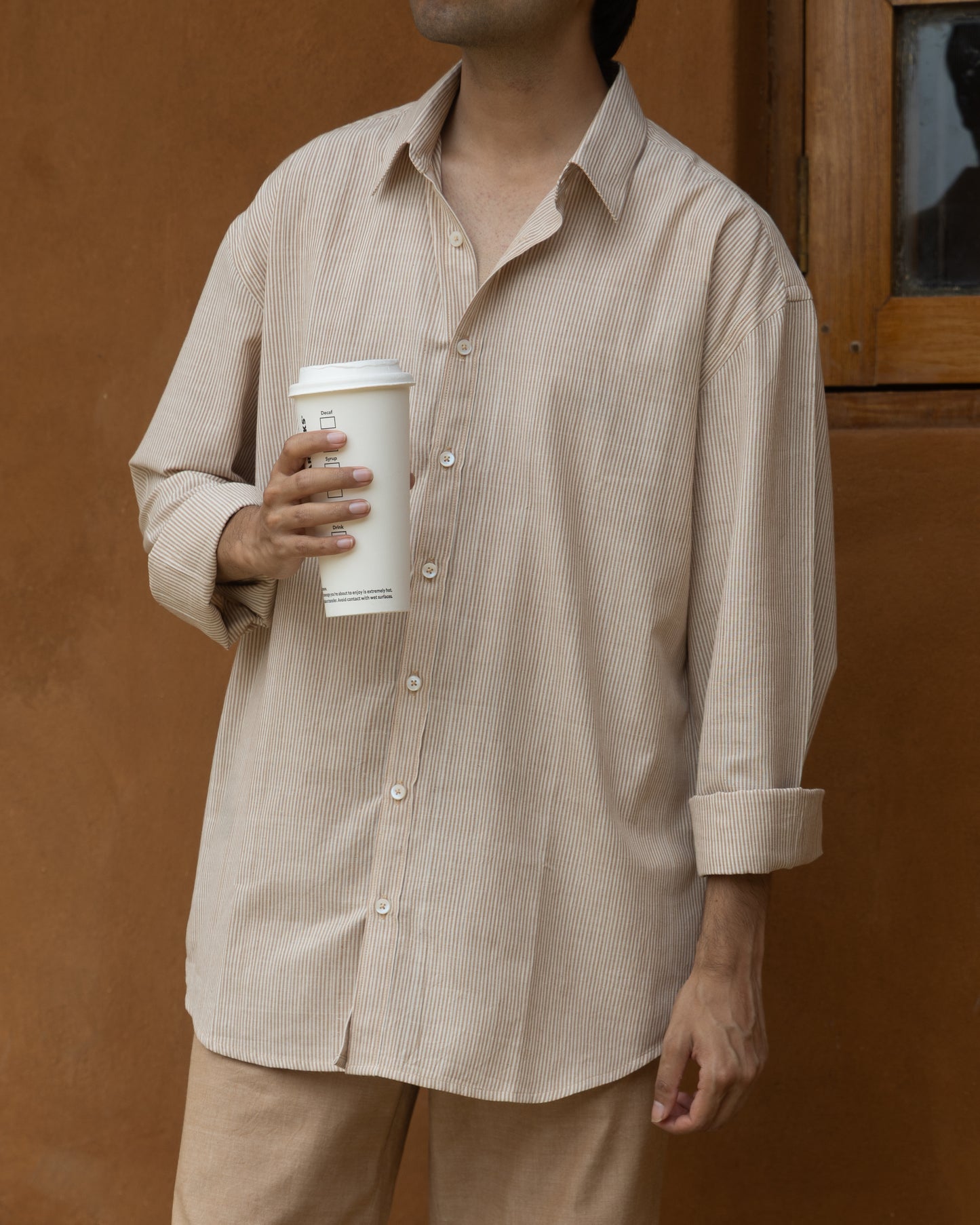 Relaxed fit handwoven khadi shirt for men in nutbrown and khaki stripes, made from organic cotton with a soft, earthy look.