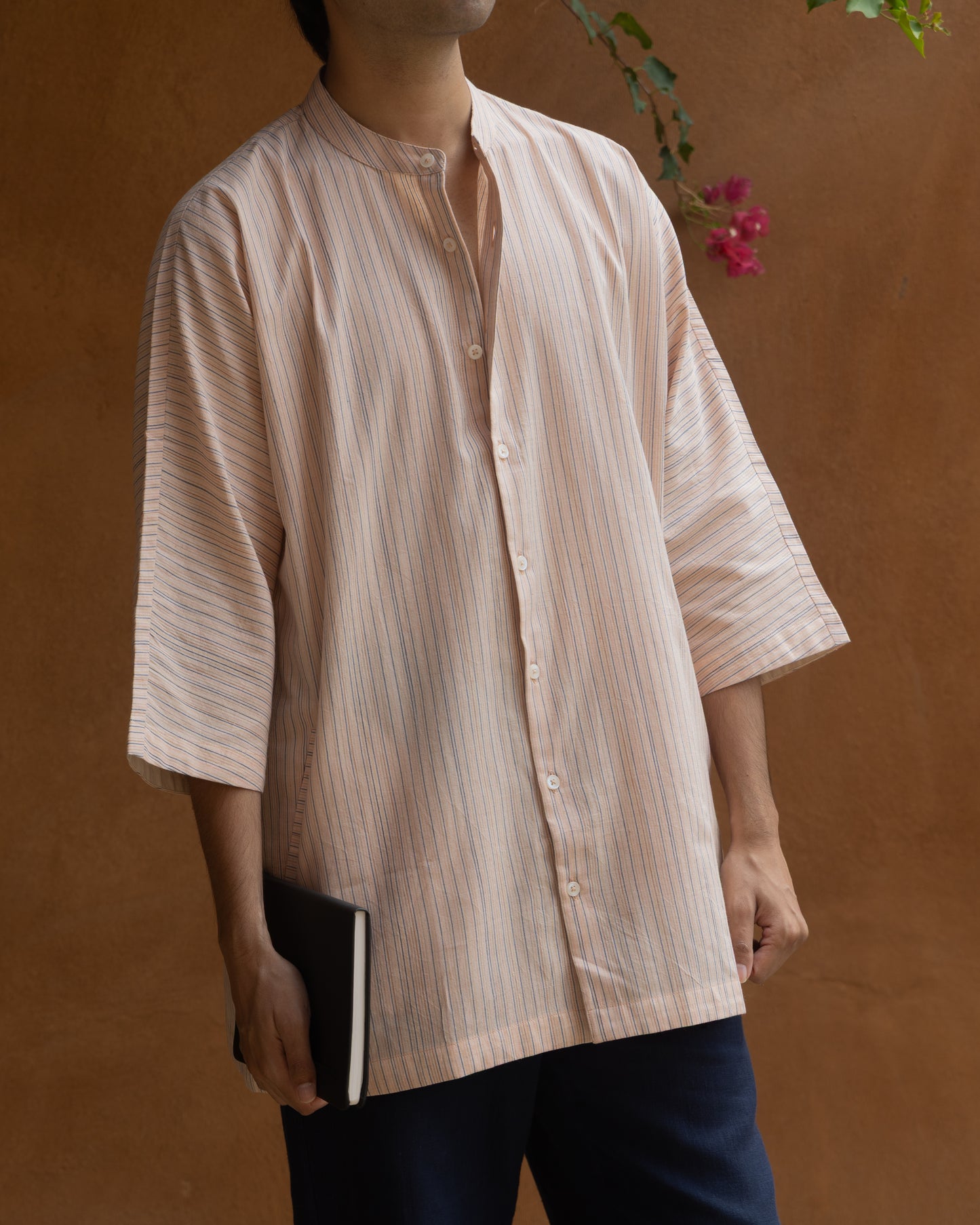 Soft pink and pastel striped khadi cotton kimono shirt for men with 3/4 sleeves, handwoven using traditional handloom techniques.