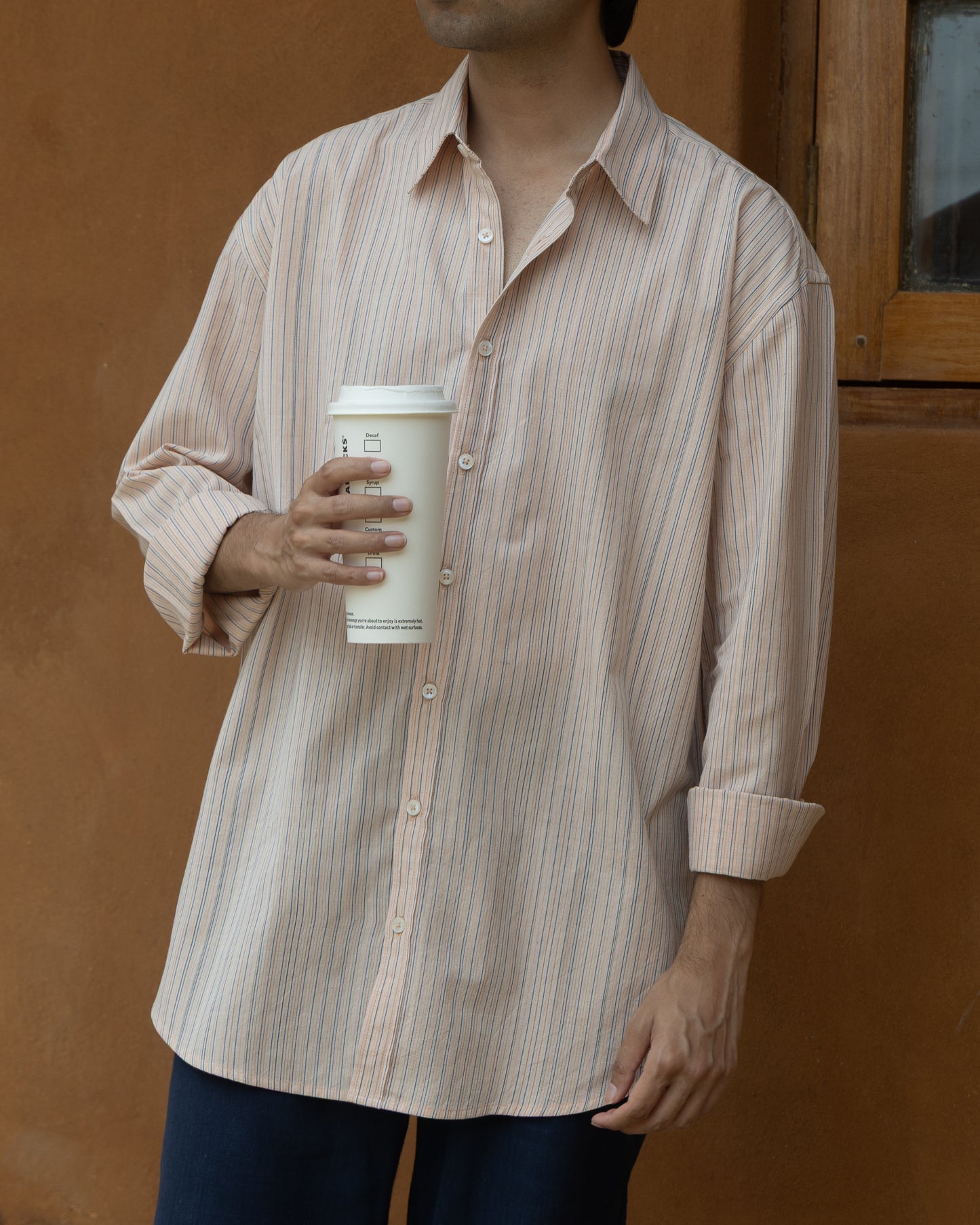 Soft pink striped khadi cotton shirt for men with a relaxed fit, handwoven from organic fabric in breathable, pastel tones.