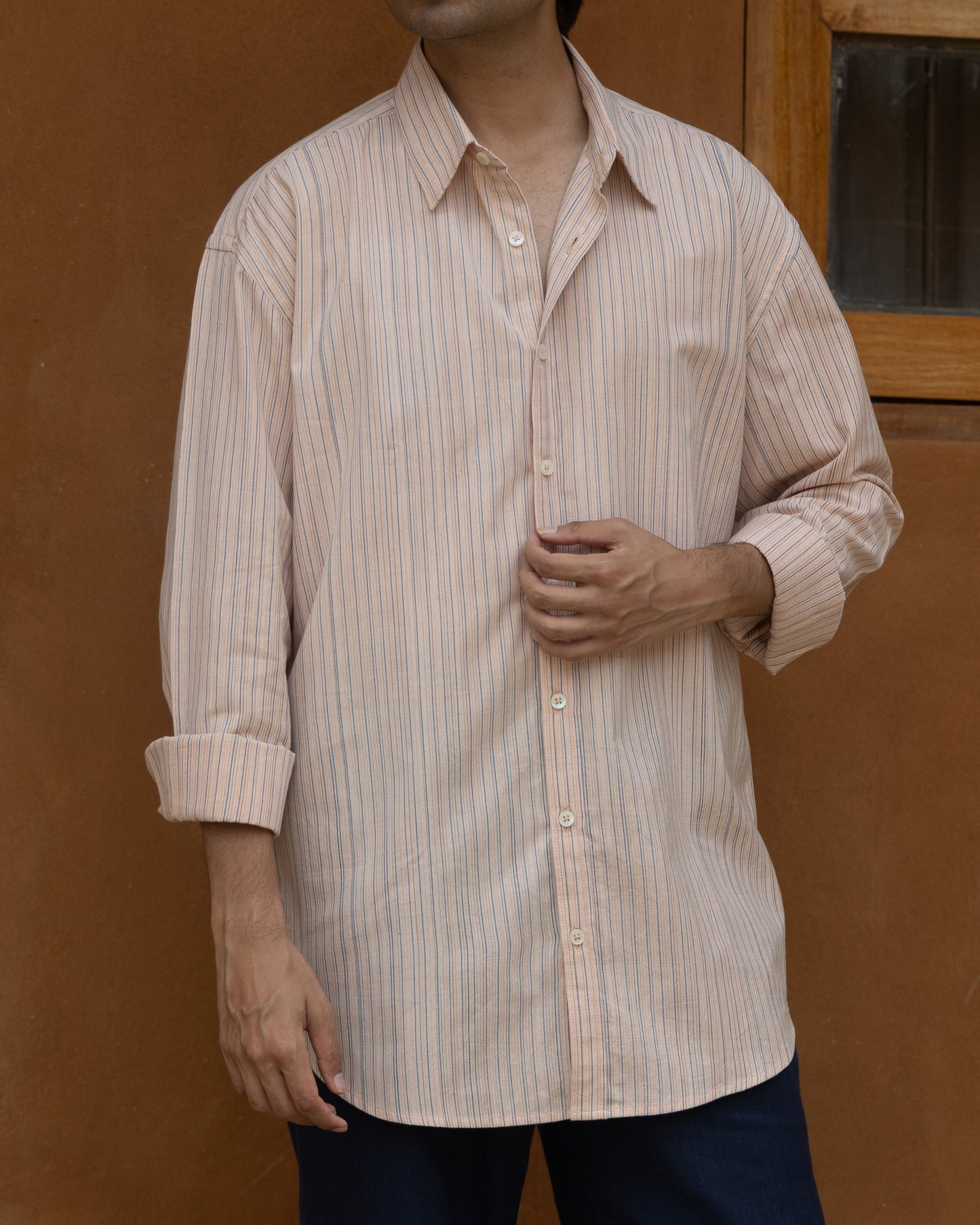 Eco-friendly men’s handloom shirt in pink guava tones with multi-stripe pattern and loose, comfortable silhouette.