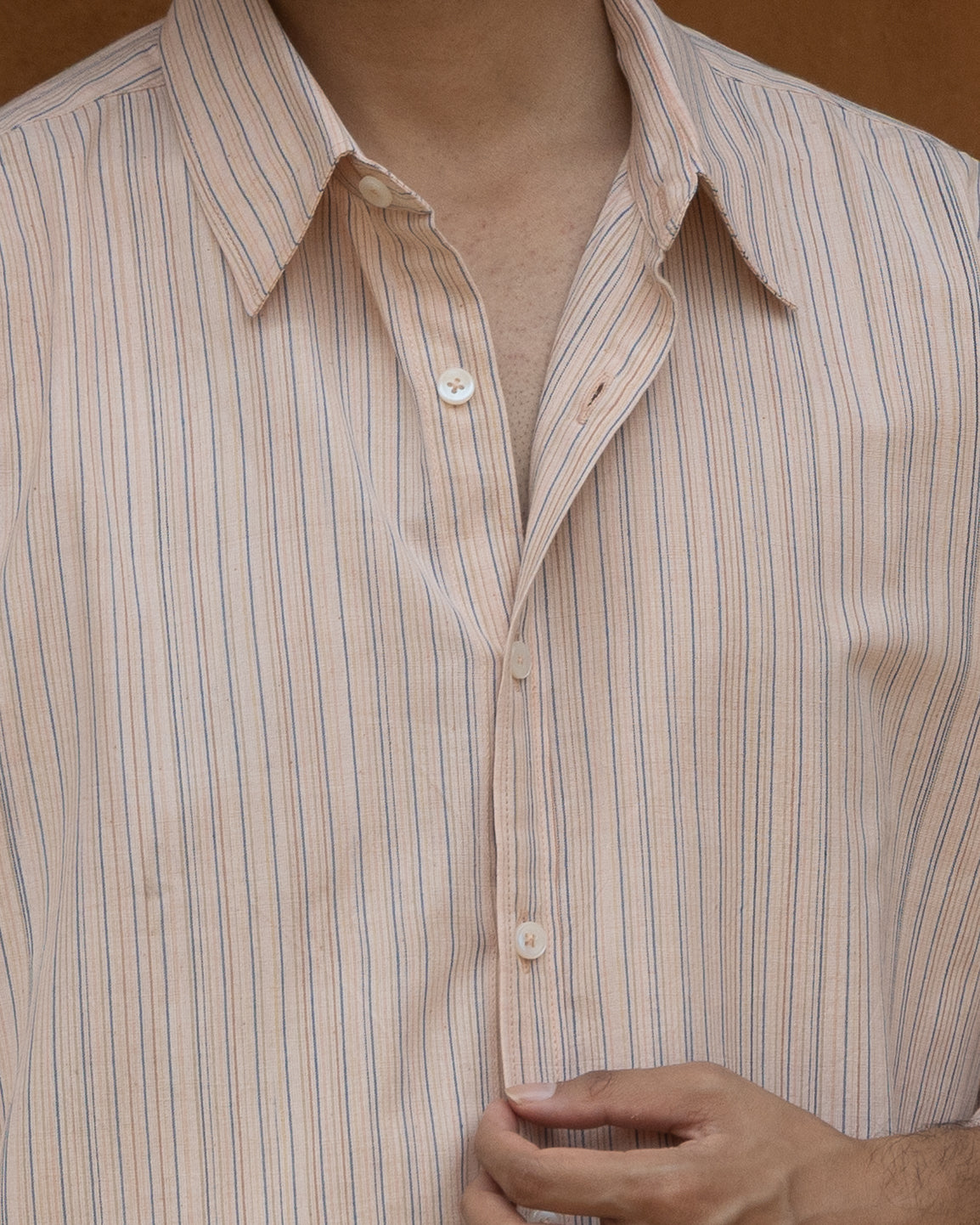 Relaxed fit pink guava striped shirt for men, made from handspun khadi cotton in light earthy tones for a cool, conscious look.