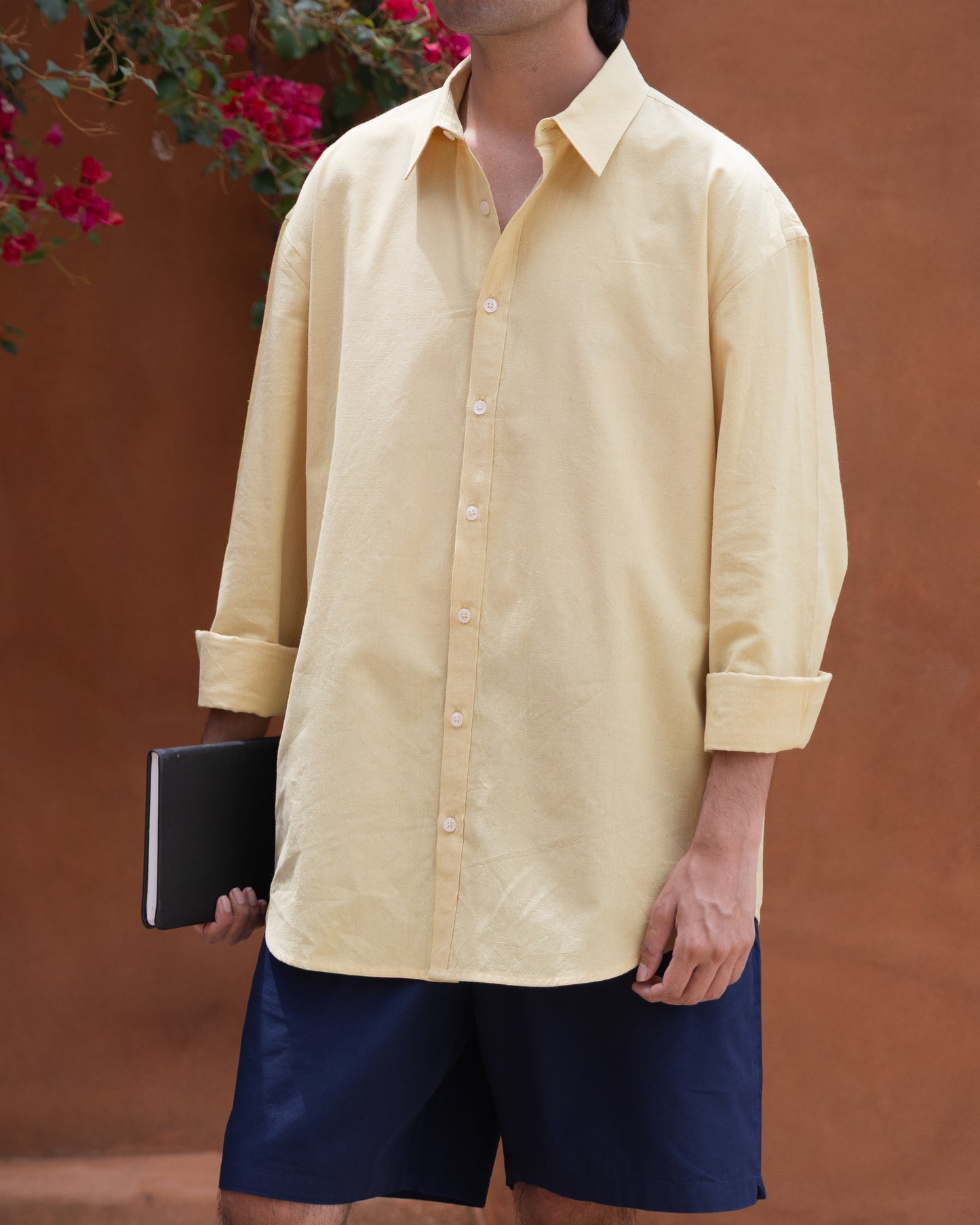 Eco-friendly men's relaxed fit shirt in turmeric latte color, made from handspun Khadi cotton with a breathable, soft texture.