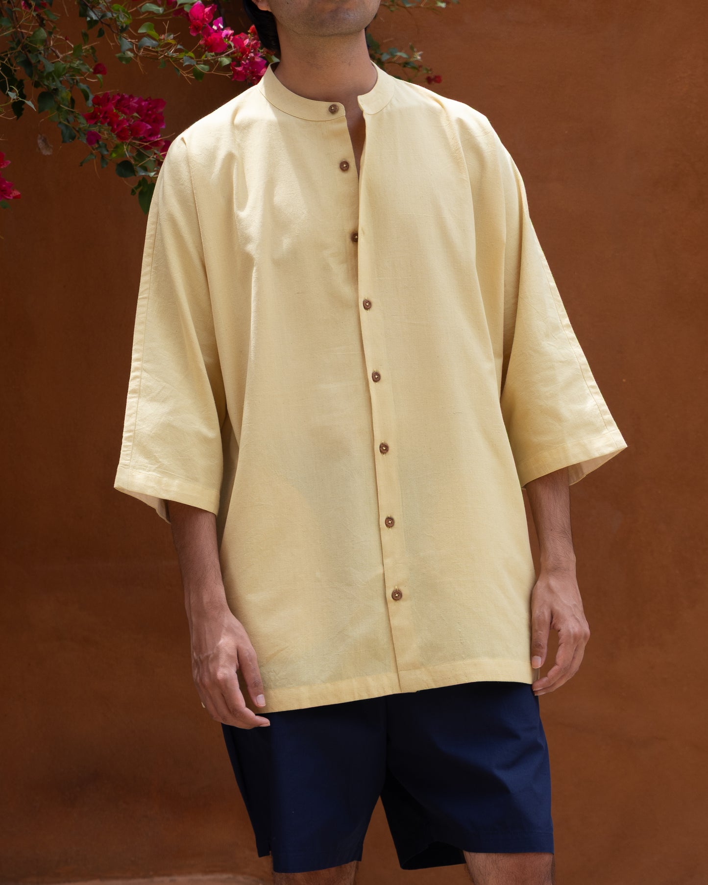 Eco-friendly men's Khadi shirt in turmeric yellow with Japanese kimono styling and organic cotton texture.