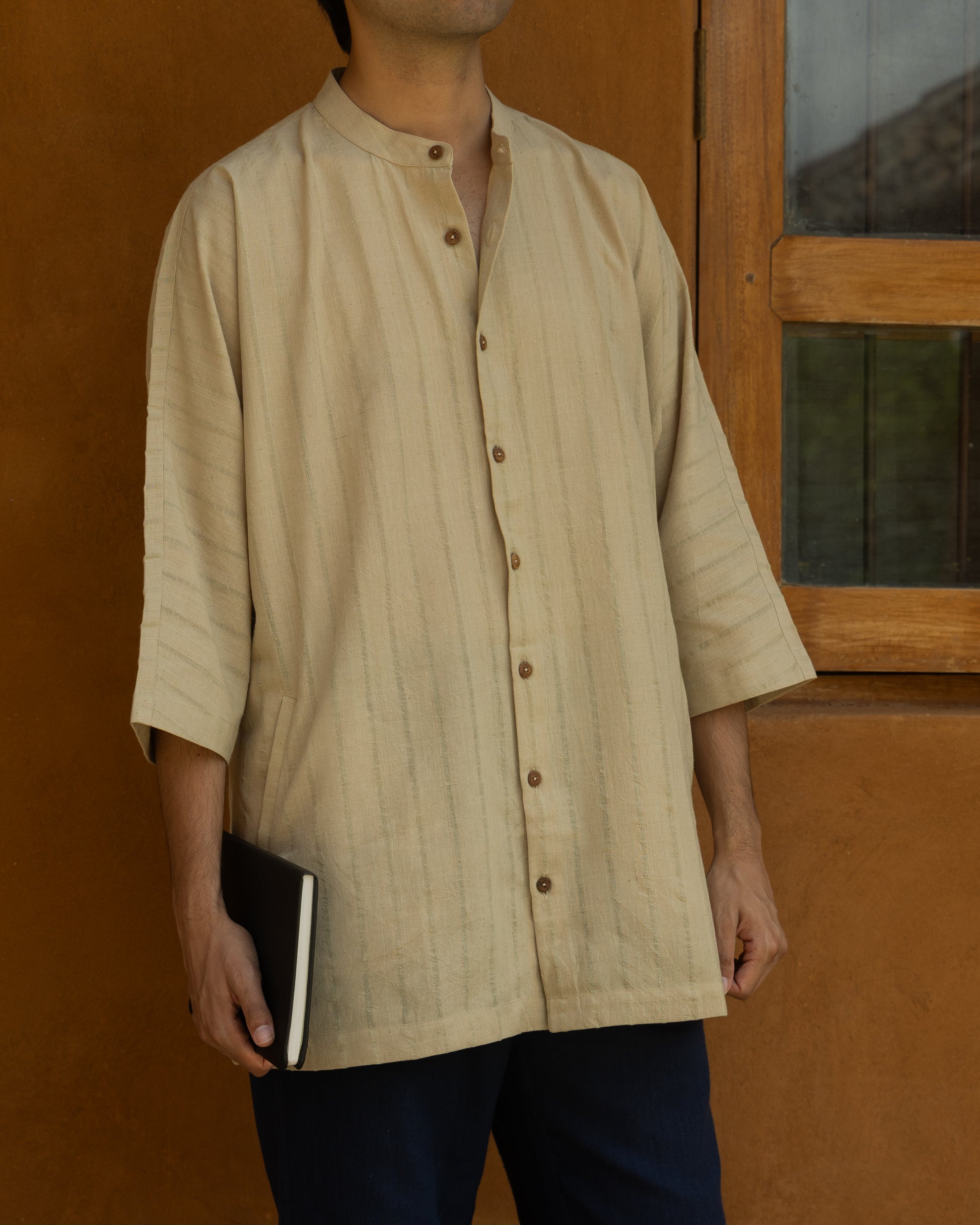 Organic cotton kimono-style shirt in basil green for men, featuring a relaxed fit, quarter sleeves, and Japanese-inspired silhouette.