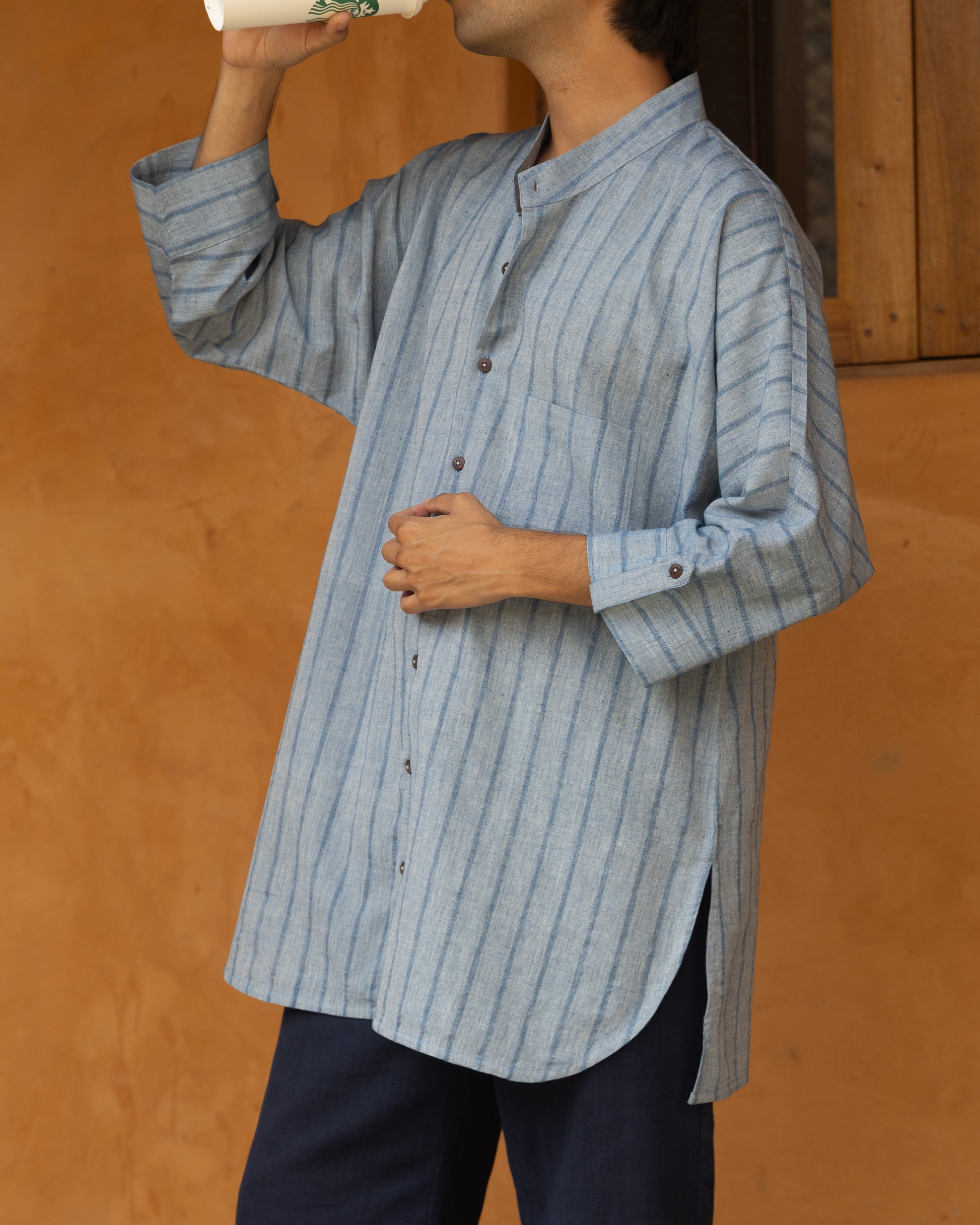 Handspun indigo khadi shirt for men featuring kimono-style sleeves and a soft, breathable handloom texture.